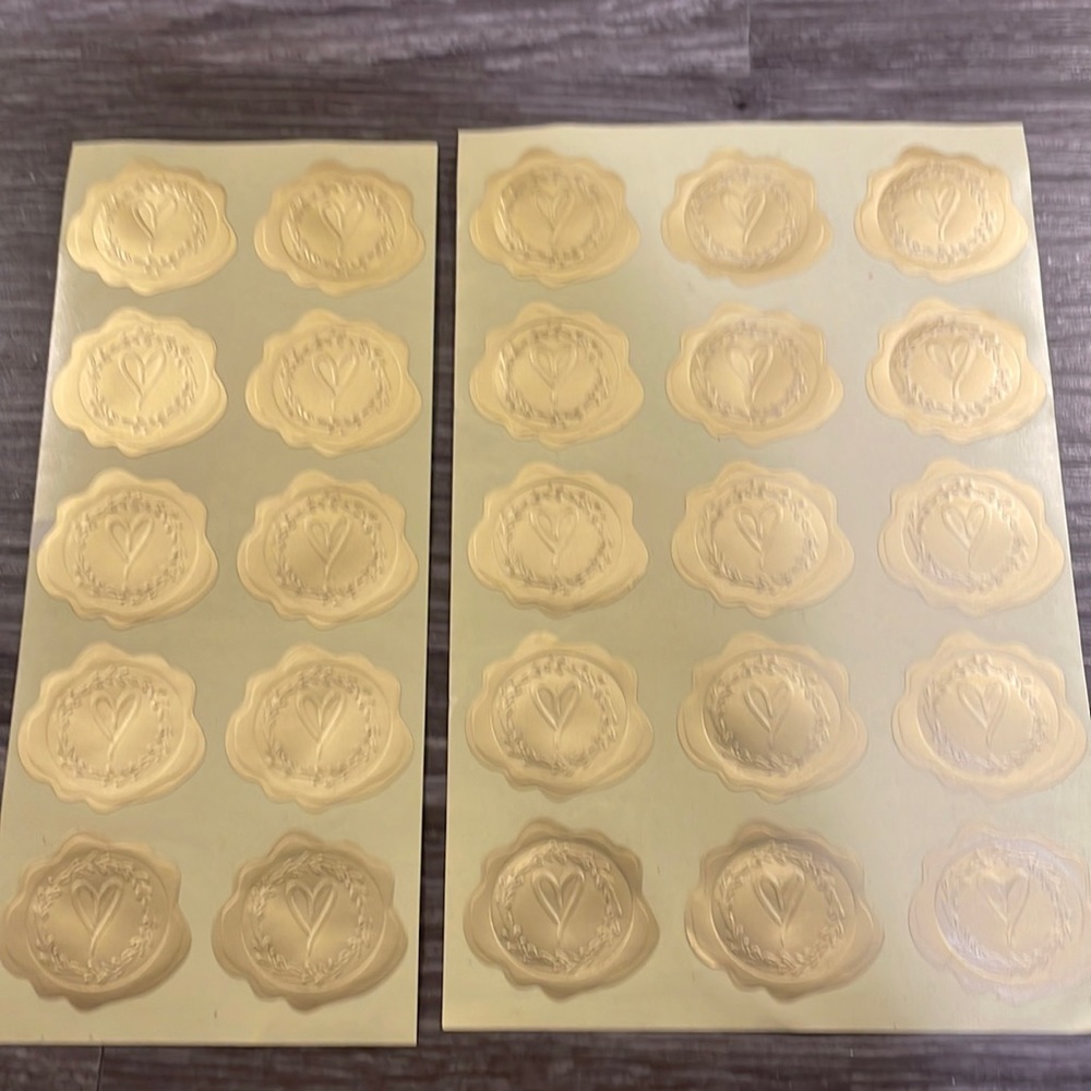 Set of 25 gold invitation/envelope seals with embossed hearts